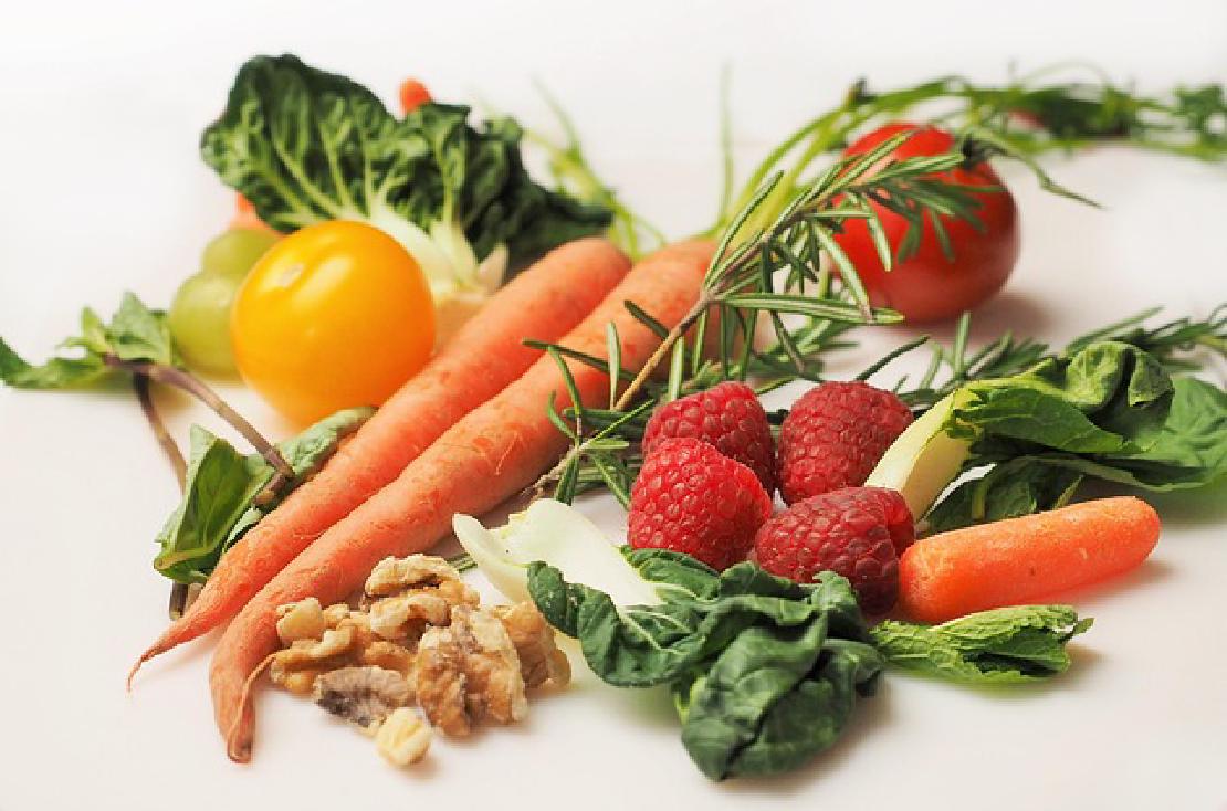 An assortment of fruits and vegetables on a white background.