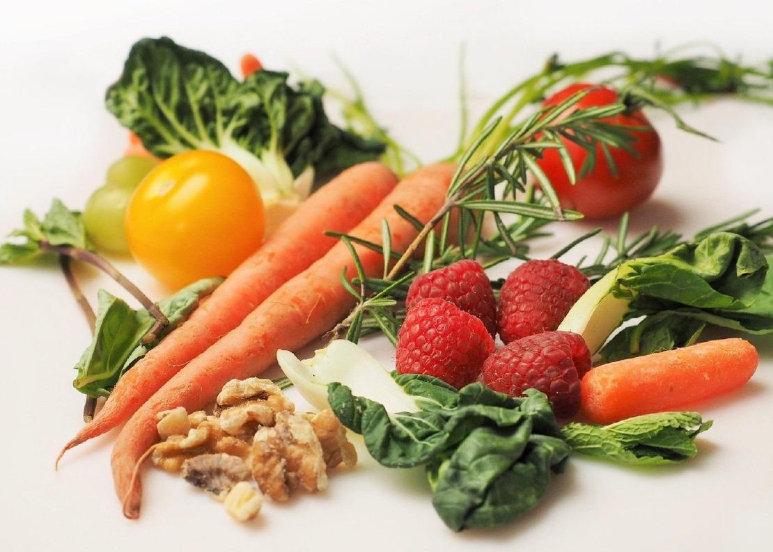 An assortment of fruits and vegetables on a white background.
