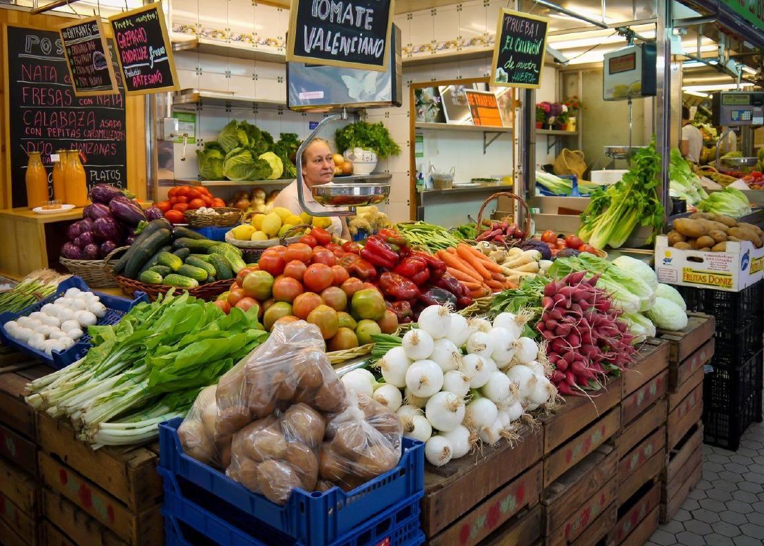 A colorful display of fruits and vegetables for sale at a market in Valencia, Spain.