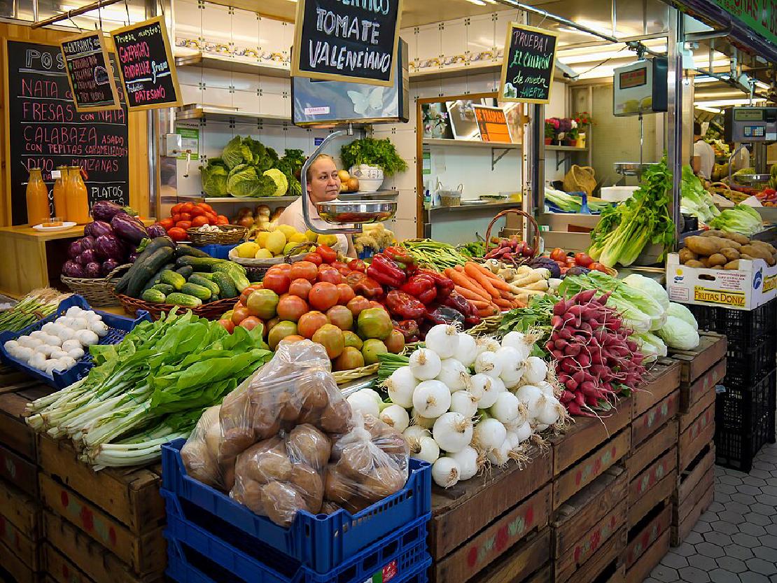 A colorful display of fruits and vegetables for sale at a market in Valencia, Spain.