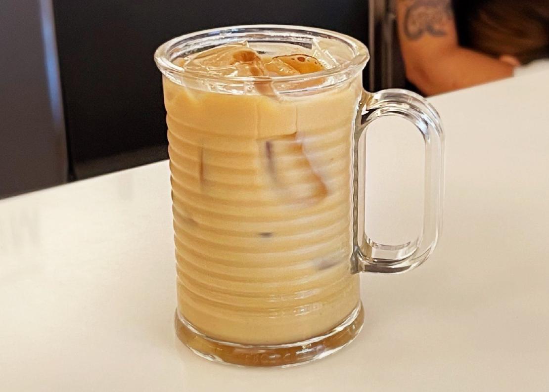A cup of iced coffee in a tall glass.
