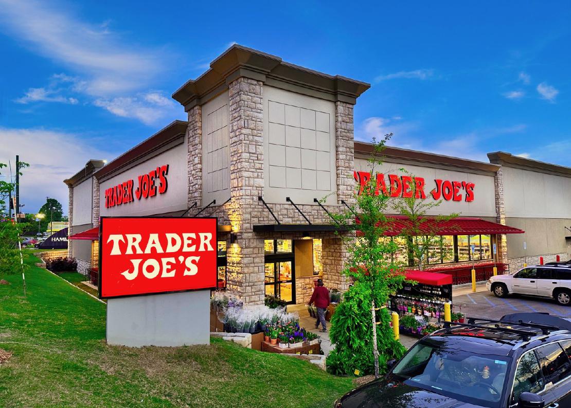 An exterior shot of a Trader Joe's store in Chattanooga, Tennessee, with the sign in front and a blue sky above.